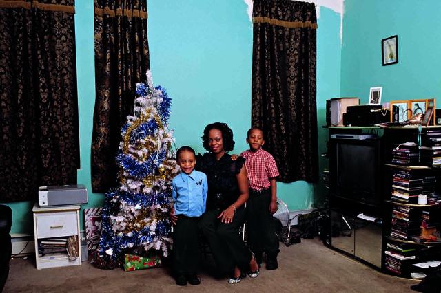 An image of a mother and two children in a living room